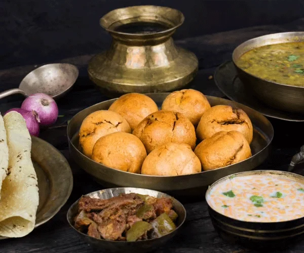 Authentic Rajasthani dal baati churma served in brass vessels