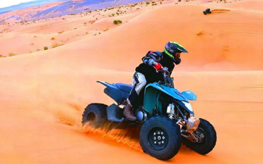 ATV quad bike tearing through the red sand dunes
