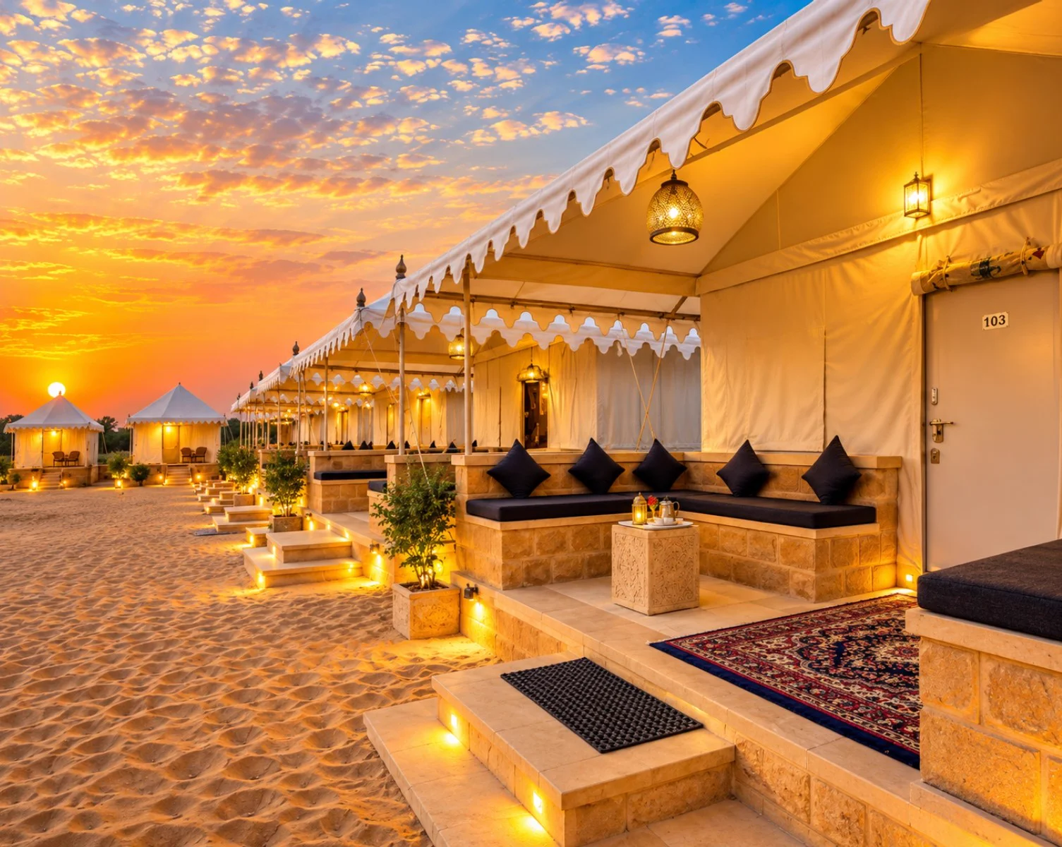 Single luxury tent exterior at golden sunset with wooden chairs on the veranda
